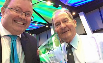 Professor Peter Halley and QUT’s Emeritus Professor Graeme George with the award.